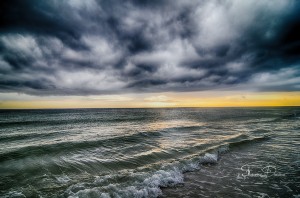 Dark Clouds and water Split By The Sunset